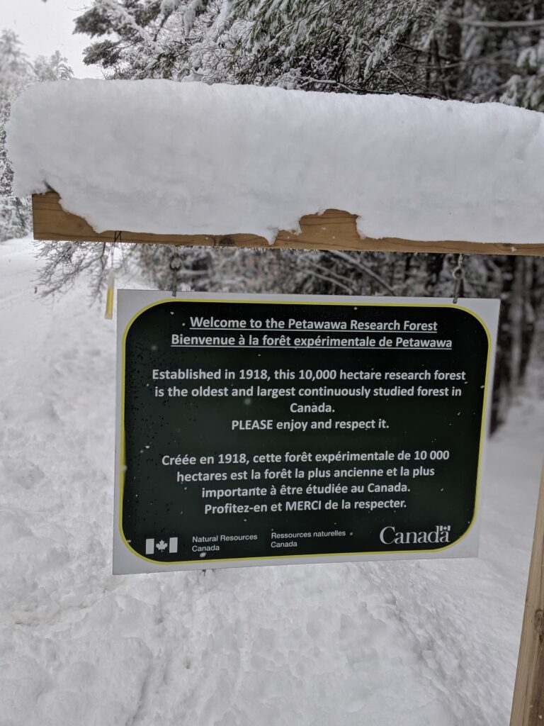 Sign of the Petawawa Research Forest covered in snow